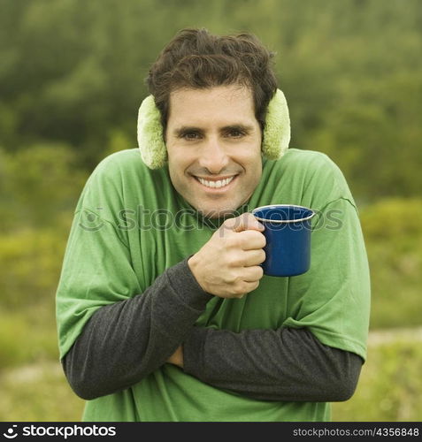 Portrait of a mid adult man holding a coffee cup