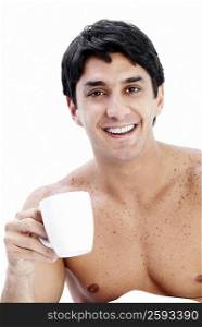 Portrait of a mid adult man holding a coffee cup and smiling