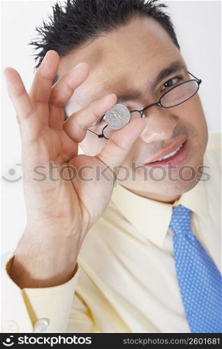 Portrait of a mid adult man holding a coin