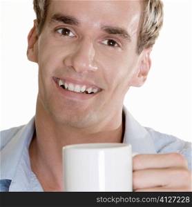 Portrait of a mid adult man holding a cup
