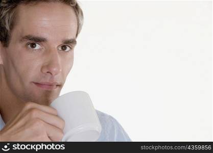 Portrait of a mid adult man holding a cup