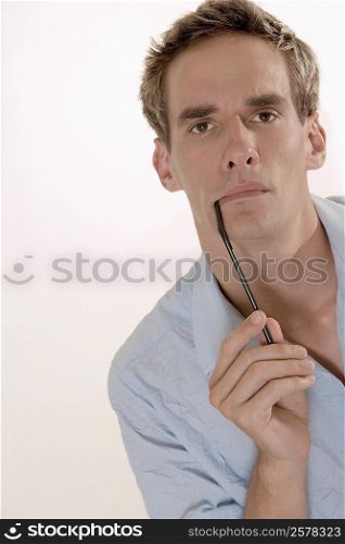 Portrait of a mid adult man holding a drinking straw