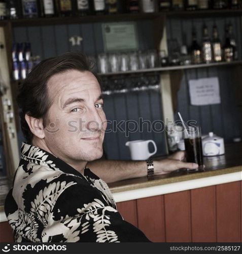 Portrait of a mid adult man holding a glass of drink