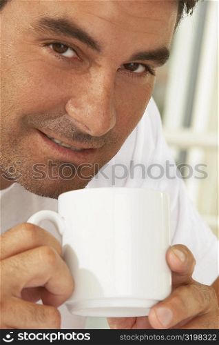 Portrait of a mid adult man holding a mug