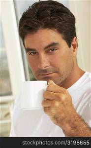 Portrait of a mid adult man holding a mug