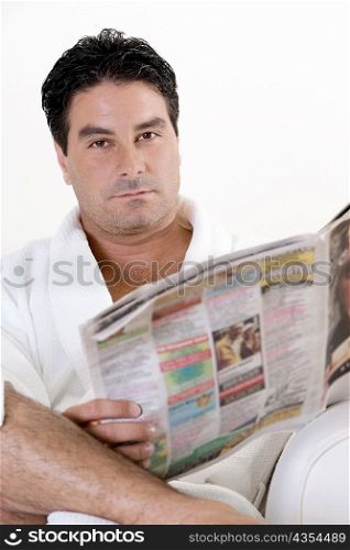 Portrait of a mid adult man holding a newspaper