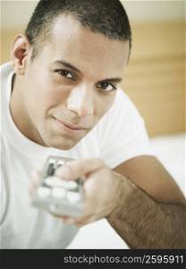 Portrait of a mid adult man holding a remote control