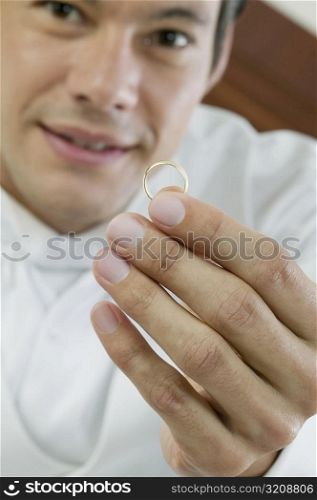 Portrait of a mid adult man holding a ring