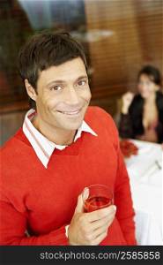 Portrait of a mid adult man holding a wine glass and smiling