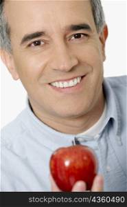 Portrait of a mid adult man holding an apple