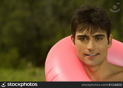 Portrait of a mid adult man in an inflatable ring