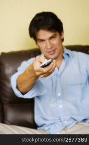 Portrait of a mid adult man operating a remote control