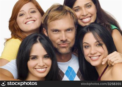 Portrait of a mid adult man posing with four young women