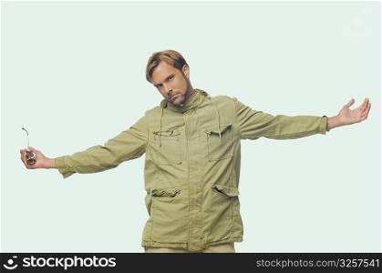 Portrait of a mid adult man posing with his arms outstretched