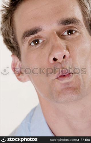 Portrait of a mid adult man puckering his lips