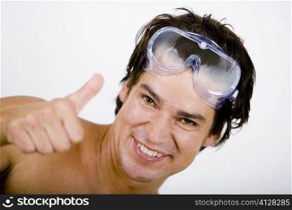 Portrait of a mid adult man showing Thumbs Up sign
