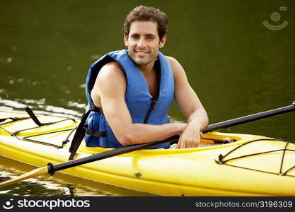 Portrait of a mid adult man sitting in a kayak