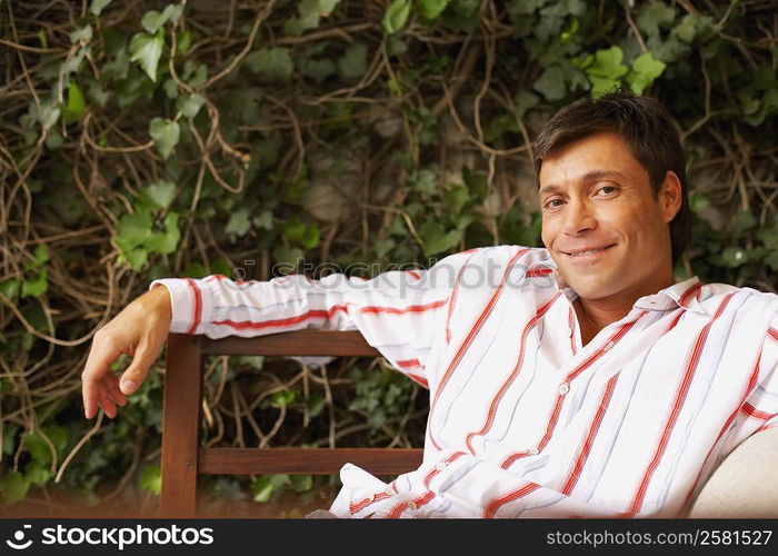 Portrait of a mid adult man sitting on a bench