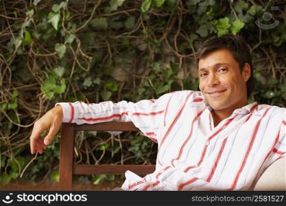 Portrait of a mid adult man sitting on a bench