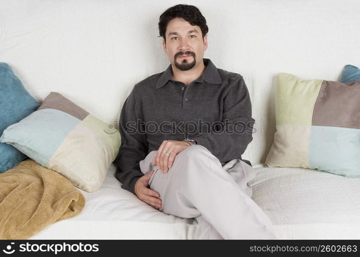 Portrait of a mid adult man sitting on a couch