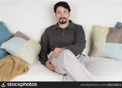 Portrait of a mid adult man sitting on a couch