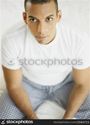 Portrait of a mid adult man sitting on the bed