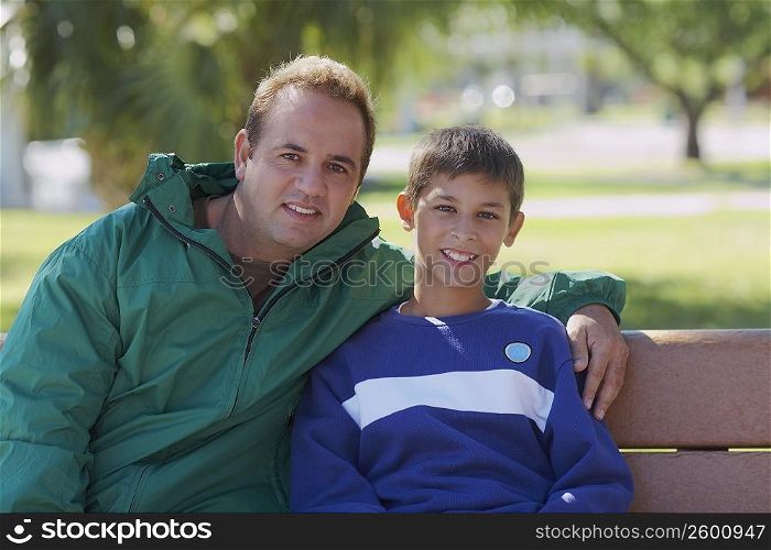 Portrait of a mid adult man sitting with his son