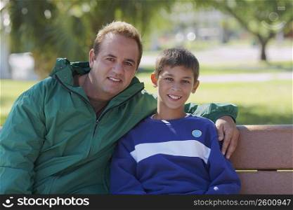 Portrait of a mid adult man sitting with his son