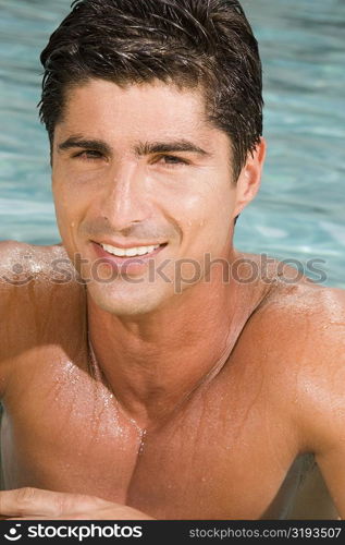Portrait of a mid adult man smiling in a swimming pool
