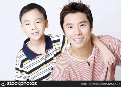 Portrait of a mid adult man smiling with his son