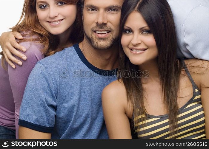 Portrait of a mid adult man smiling with two young women