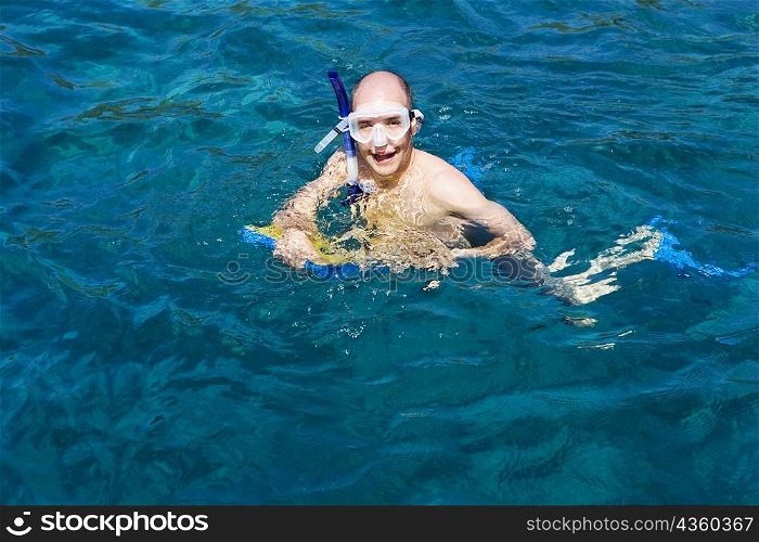 Portrait of a mid adult man snorkeling in the sea
