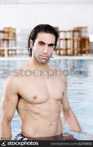 Portrait of a mid adult man standing in a swimming pool