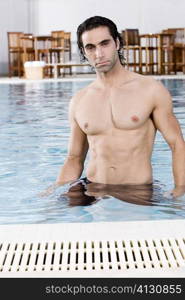 Portrait of a mid adult man standing in a swimming pool