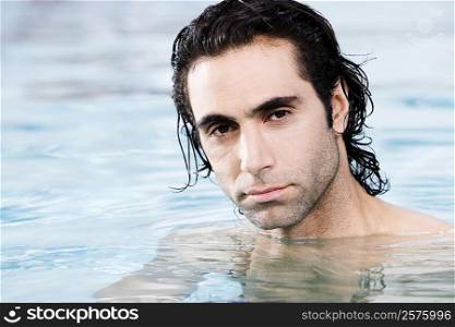 Portrait of a mid adult man swimming in a swimming pool