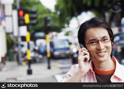 Portrait of a mid adult man talking on a mobile phone and smiling
