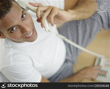 Portrait of a mid adult man talking on the telephone and smiling