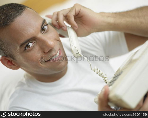 Portrait of a mid adult man talking on the telephone and smiling