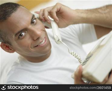 Portrait of a mid adult man talking on the telephone and smiling