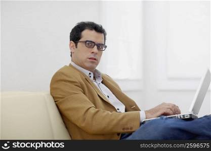 Portrait of a mid adult man using a laptop