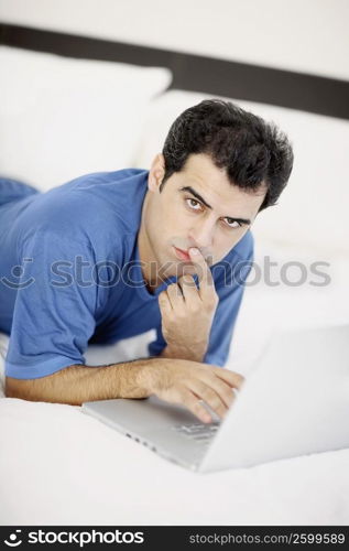 Portrait of a mid adult man using a laptop