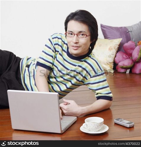 Portrait of a mid adult man using a laptop