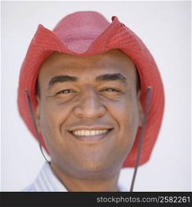 Portrait of a mid adult man wearing a cowboy hat and smiling