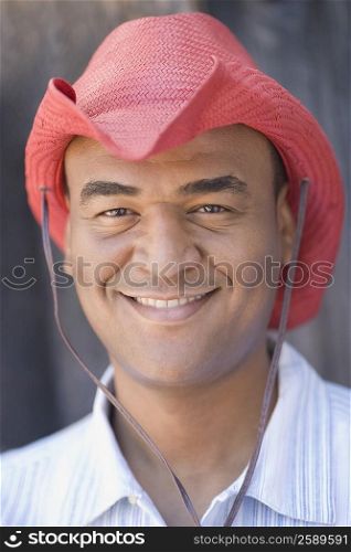 Portrait of a mid adult man wearing a cowboy hat and smiling