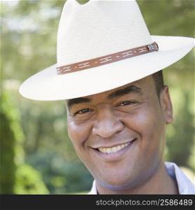 Portrait of a mid adult man wearing a hat and smiling