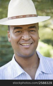 Portrait of a mid adult man wearing a hat and smiling