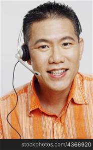 Portrait of a mid adult man wearing a headset and smiling