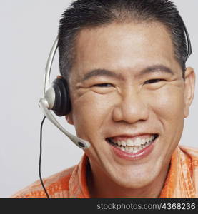 Portrait of a mid adult man wearing a headset and smiling