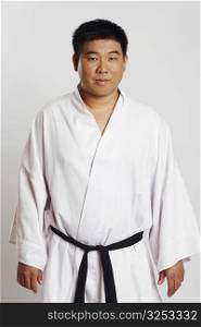 Portrait of a mid adult man wearing a karate uniform