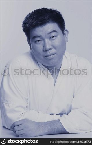 Portrait of a mid adult man wearing a karate uniform
